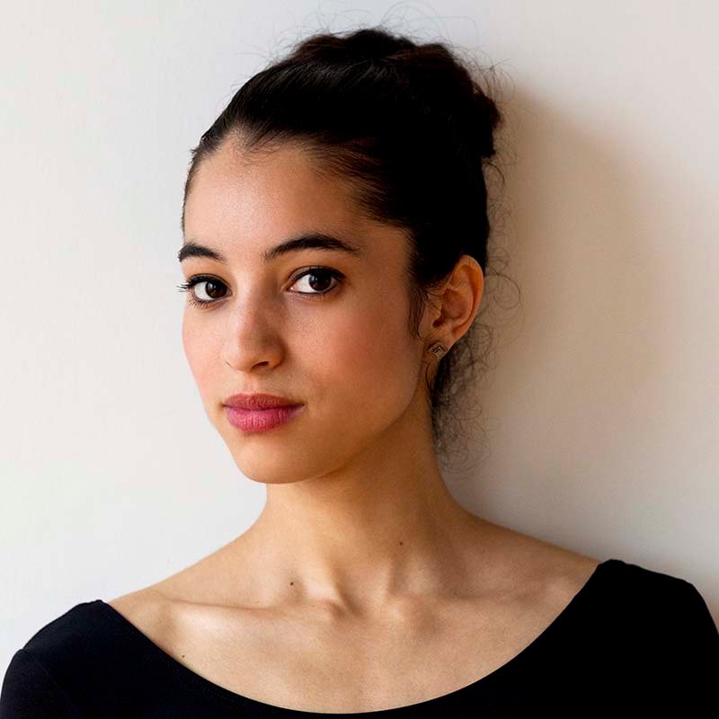 Portrait Of Confident Ballet Dancer Standing Against Wall In Bal